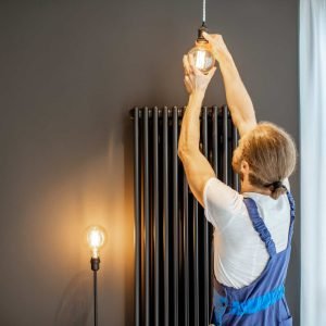 handyman replacing lightbulb at home 1